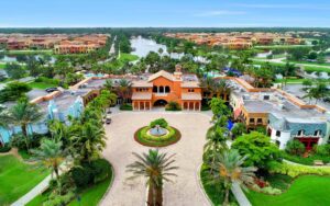 A large orange building with palm trees in the middle of it.