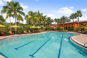 A swimming pool with many chairs and umbrellas