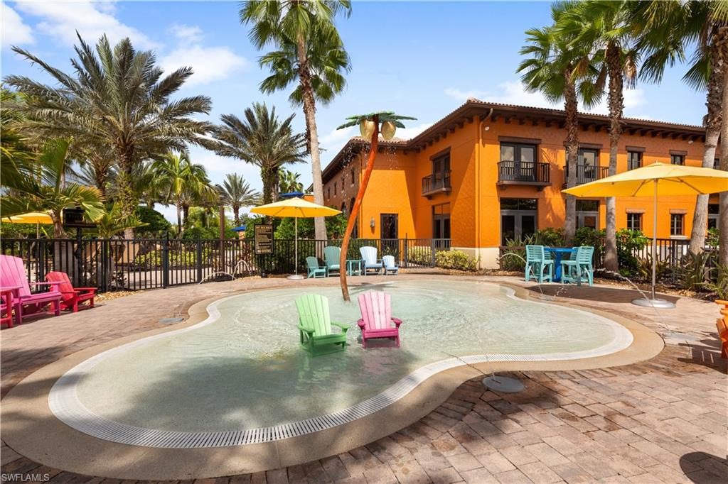 A pool with two chairs and an umbrella.