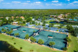 A group of tennis courts with many green covers.