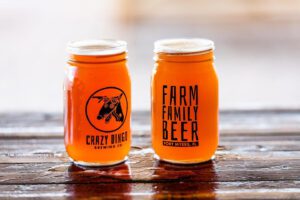 Two jars of beer sitting on top of a table.