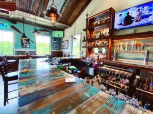 A bar with many tables and chairs in it