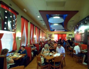 A restaurant with people sitting at tables eating.