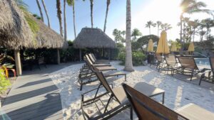 A beach with many chairs and umbrellas on the sand