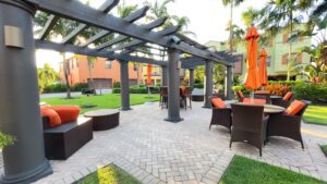 A patio with an umbrella and chairs in it