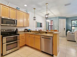 A kitchen with stainless steel appliances and wooden cabinets.