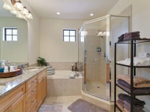 A bathroom with a tub, shower and sink.